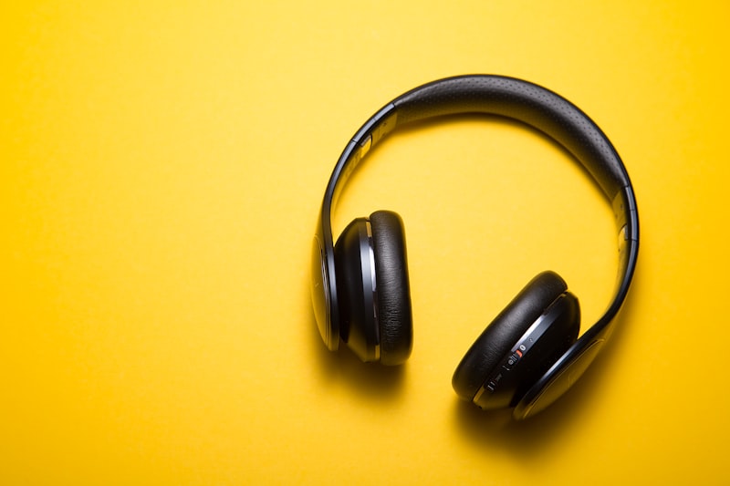 Wireless headphones photographed on a plain surface